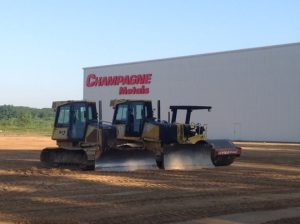 bulldozers and rollers working on construction of champagne metals building expansion