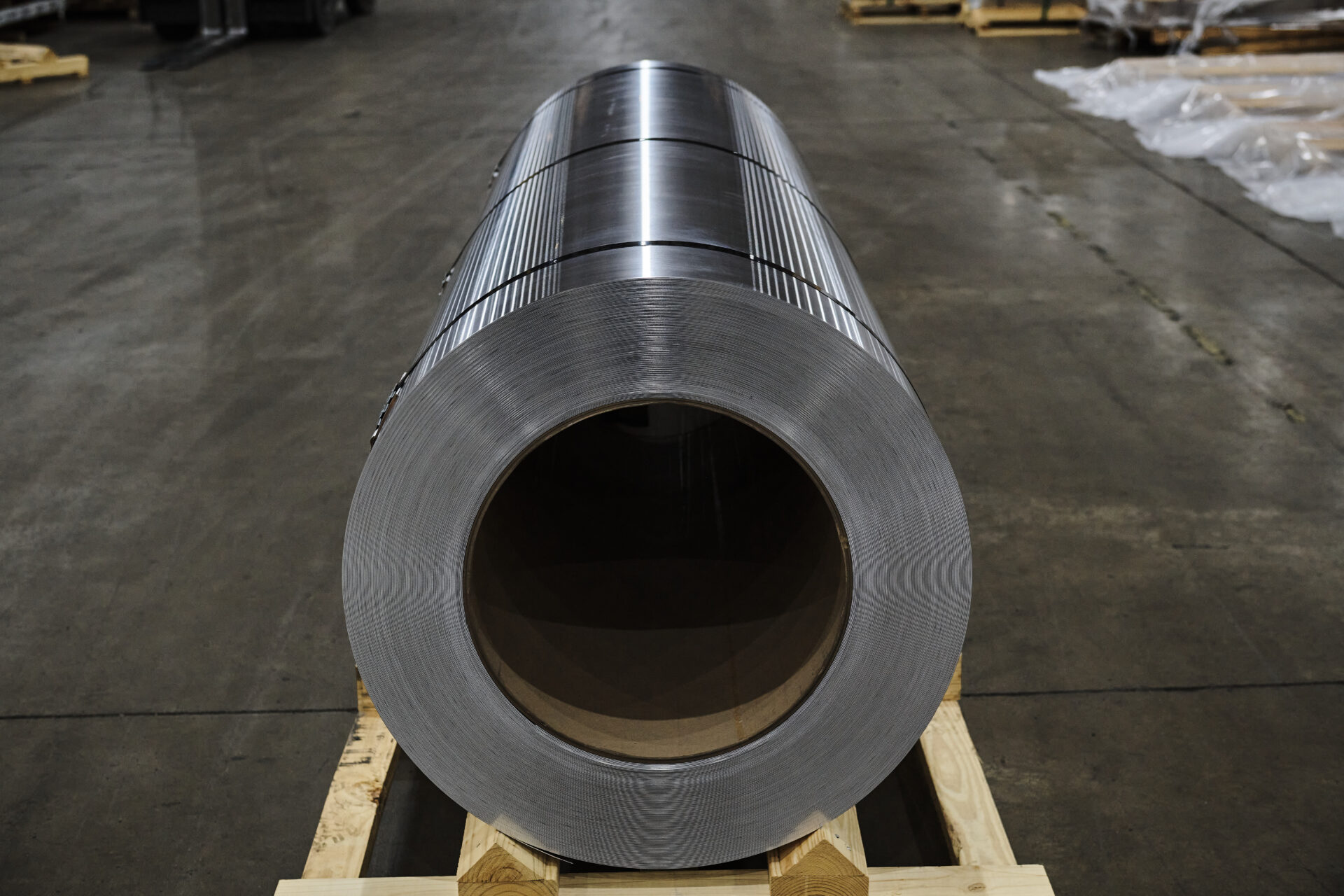 image of aluminum coil on a pallet on a concrete floor
