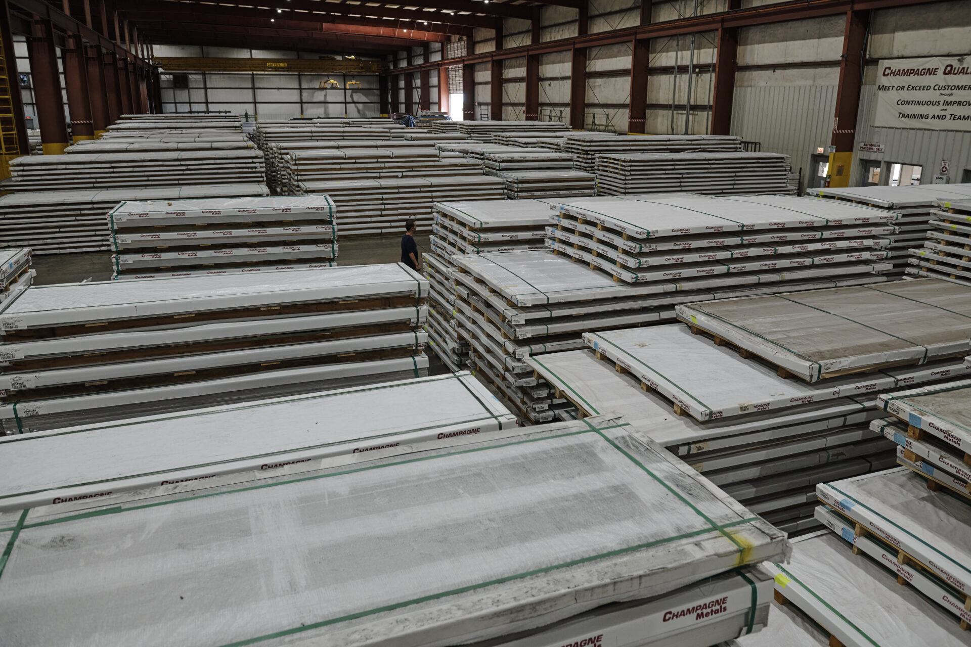 large champagne metals warehouse full of stacks of aluminum sheet