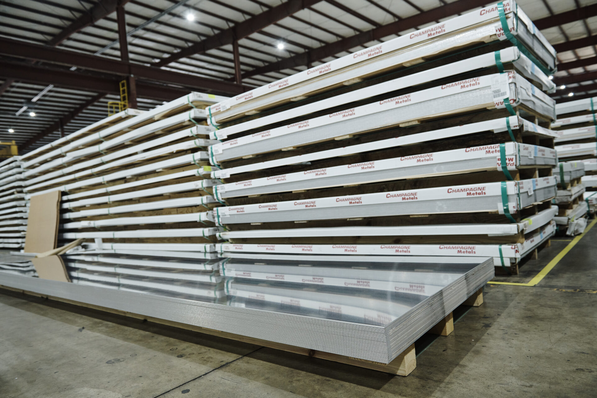 stacks of aluminum sheet with champagne metals logo on the sides
